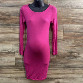 Front view of pink long-sleeve maternity bodycon dress with fitted shape and visible bump on black mannequin wood background