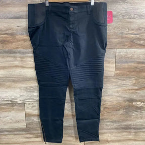 Front view of black Isabel maternity jeggings size 14 showing ribbed knees, ankle zips and over-belly panel on wood floor