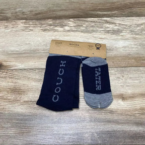 Top down view of navy dad and child socks showing COUCH on adult sock and TATER on child sock on wood background