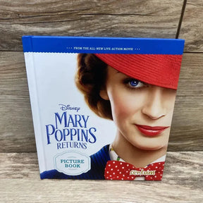 Front of Mary Poppins Returns hardcover showing cover close-up with red hat and polka-dot bow tie on wooden surface