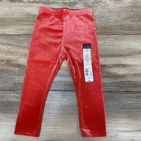 Flat lay of red Okie Dokie velour baby leggings (12M) showcasing elastic waistband and soft velour texture on wood background