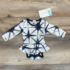 Flat lay of Monica and Andy Shibori Dress Bodysuit sz 0-3m in navy and white tie-dye with peplum skirt and hangtag on wood