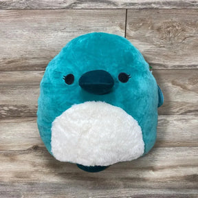 Front view of 14-inch green Squishmallows Selassi platypus plush showing white fuzzy belly, embroidered eyes and dark teal bill on wood plank background